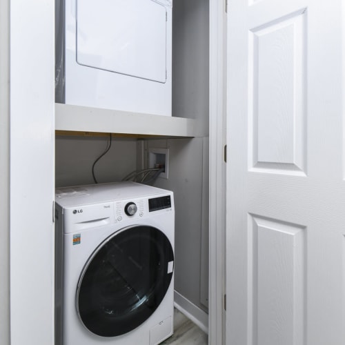 Resident and their daughter using the laundry facility at Reserves at Tidewater in Norfolk, Virginia