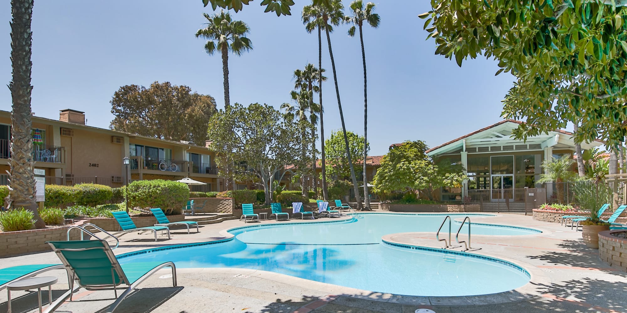 Enjoy a large resident swimming pool at Mediterranean Village Apartments in Costa Mesa, California