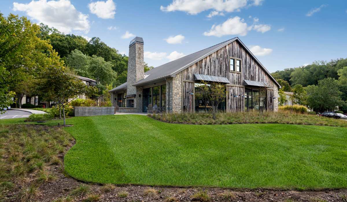 Community exterior building view with green lawn at The Lakes Bellevue in Nashville, Tennessee