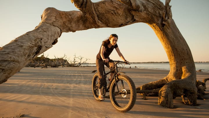 Woman rides her bike on Jekyll Island, one of the barrier islands off the Georgia coast.