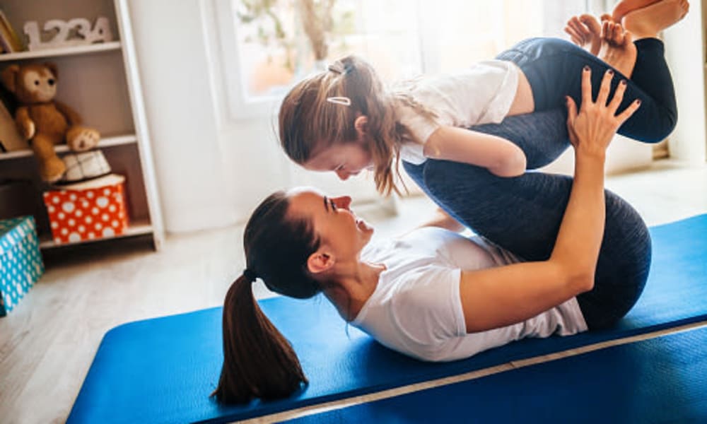 Mother and daughter doing yoga at Iris Apartments in Memphis, Tennessee