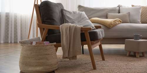Spacious living room with a chair and couch at Orange Wood Court in Sherman Oaks, California