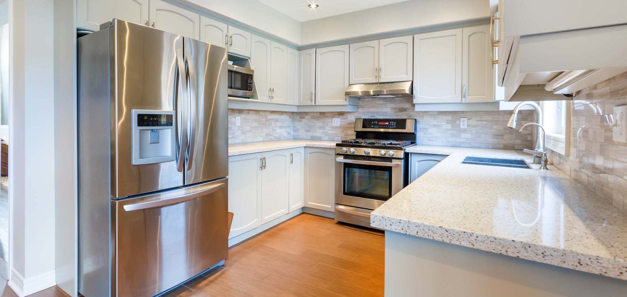 Stainless steel refrigerator and stove at Avia Lofts at Maple Road in Amherst, New York
