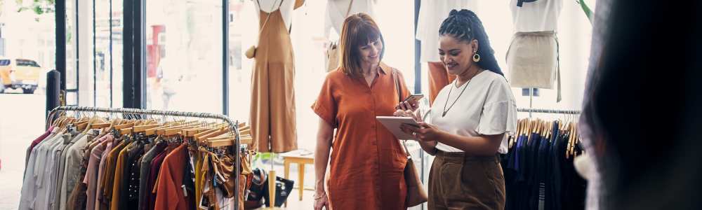 Resident woman shopping in a nearby boutique at Vivo Living Summerville in Summerville, South Carolina
