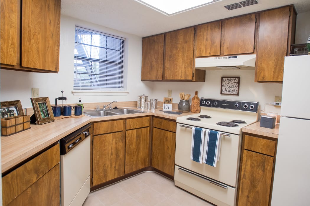 Kitchen with white appliances at Copperfield Apartments in Oklahoma City, Oklahoma