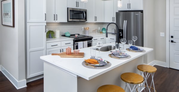 Spacious kitchen with island in model apartment home at The Local in Sugar Hill, Georgia