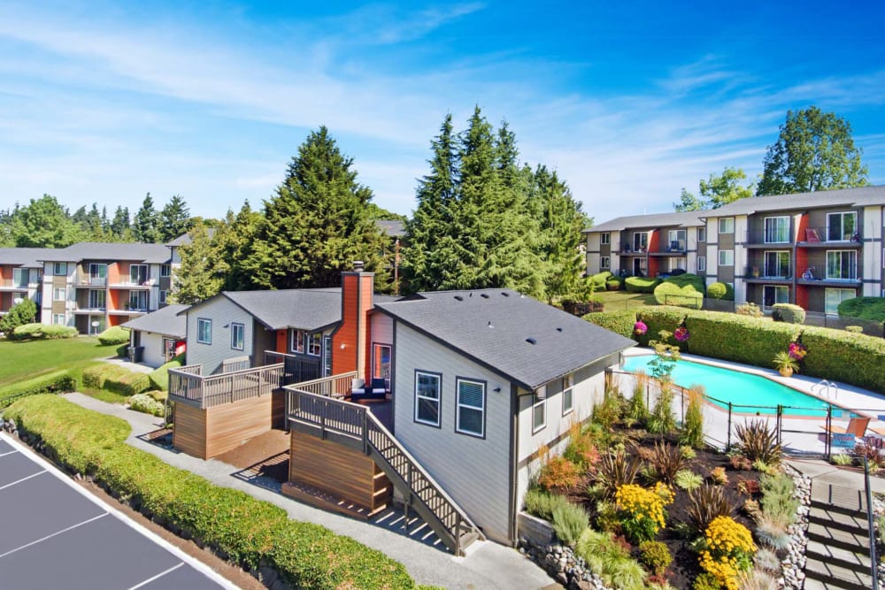 Leasing office with the swimming pool area and resident buildings in the background at Haven Apartment Homes in Kent, Washington