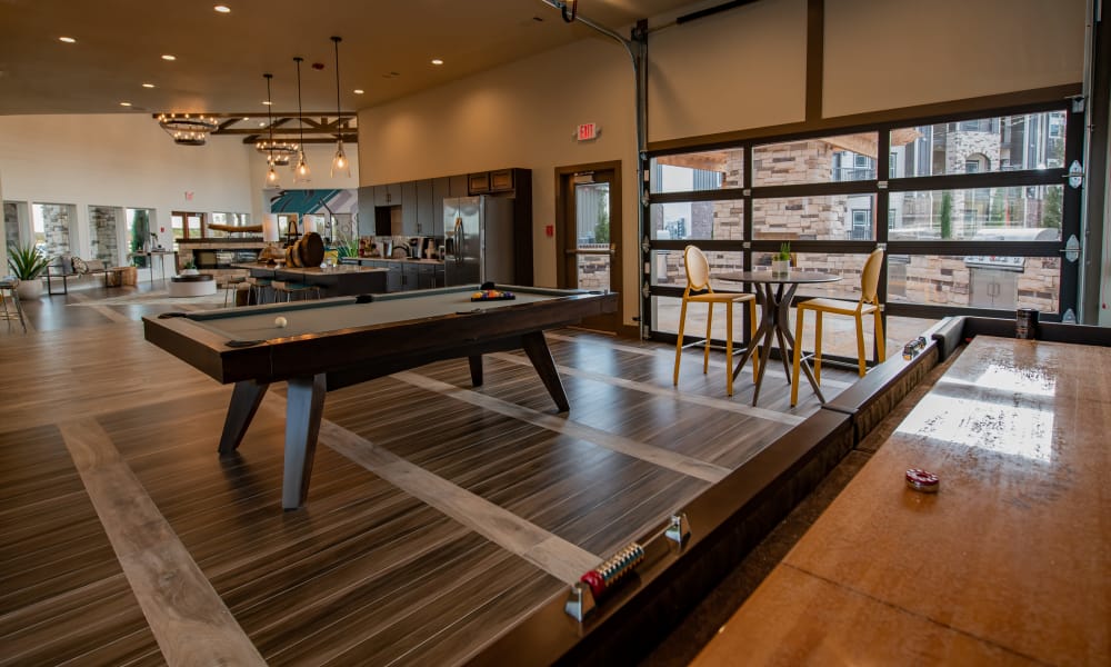 Clubhouse with shuffleboard and billiards at Stonehorse Crossing Apartments in Oklahoma City, Oklahoma