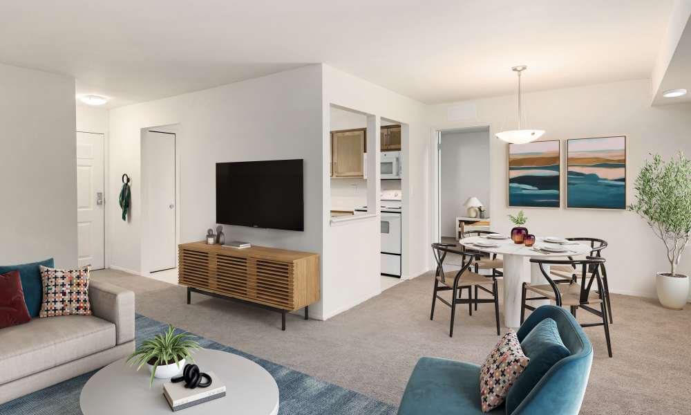 View of dining room and kitchen from the living room of a model apartment at Farmington Oaks Apartments in Farmington, Michigan