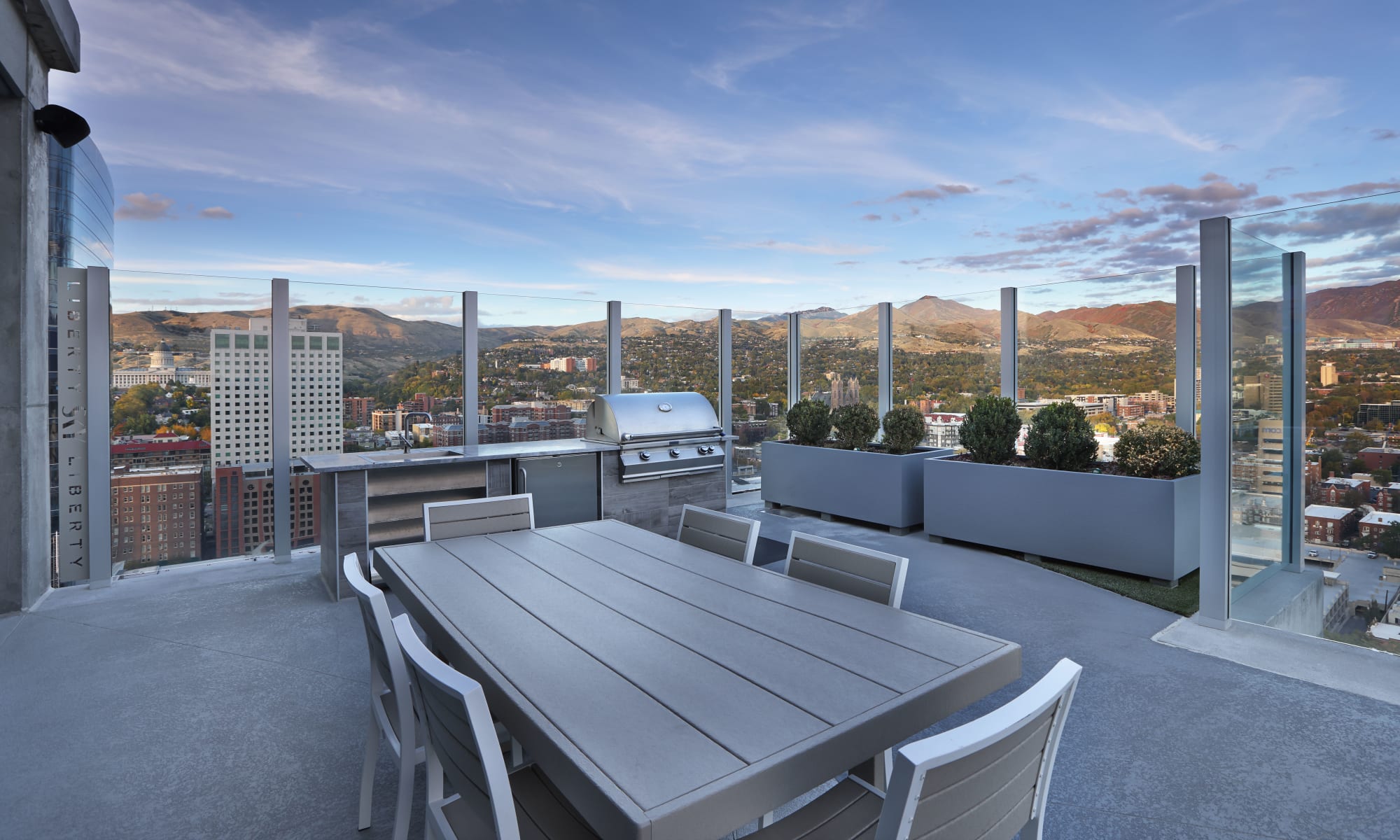 Patio with table and grill and mountain view at Luxury high-rise community of Liberty SKY in Salt Lake City, Utah