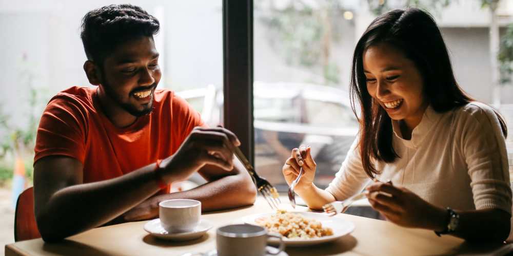 Happy couple having food in a restaurant near Cadillac Flats in Napa, California