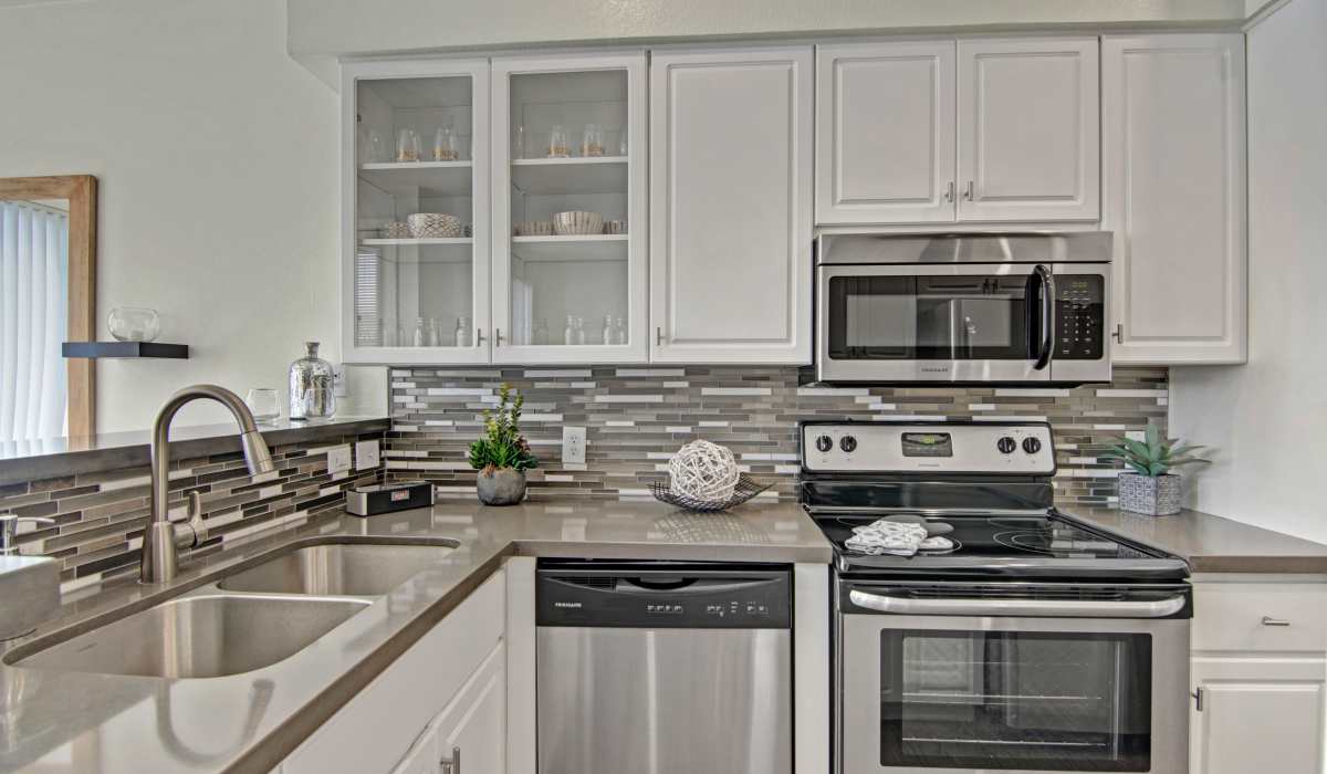 Kitchen with white cabinet and waterfall sink at Dryden in Phoenix, Arizona