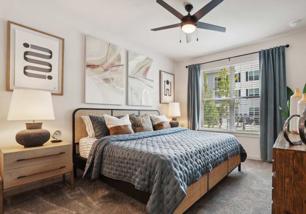 Model bedroom with wood-style flooring at The Southerly at Orange City in Orange City, Florida