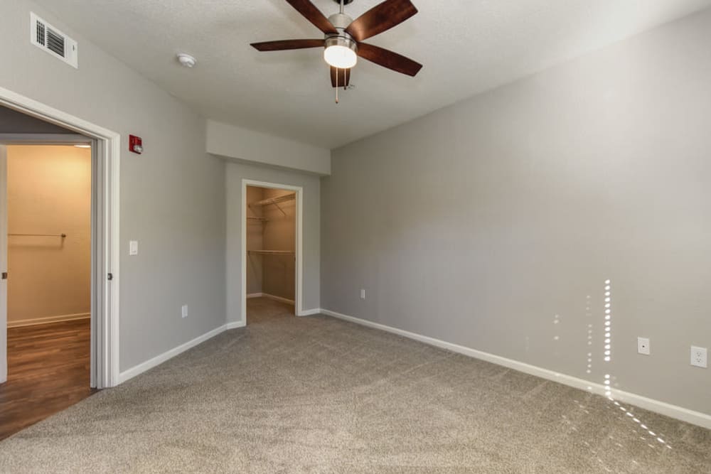 Bedroom with walk-in closet at River Oaks Apartment Homes in Vacaville, California