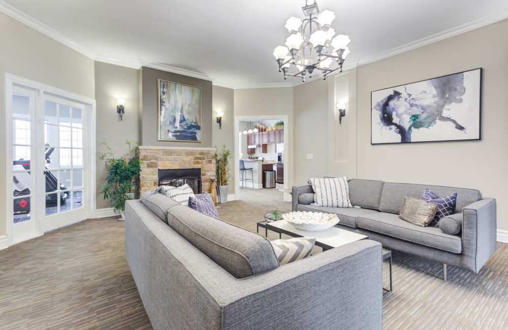 Sitting area in front of the fireplace in the resident clubhouse at The Gates of Deer Grove Apartment Homes in Palatine, Illinois