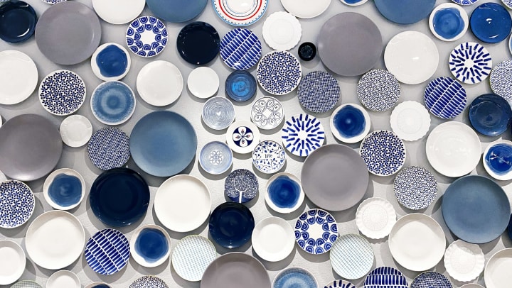 Various sizes and color dishes lying on a flat surface