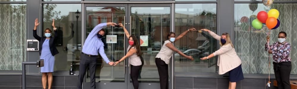 Employees wearing a mask outside of Edgewood Management in Gaithersburg, Maryland
