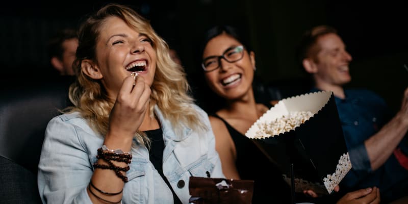 A resident eating popcorn at a movie theater near Carpenter Park in Patuxent River, Maryland