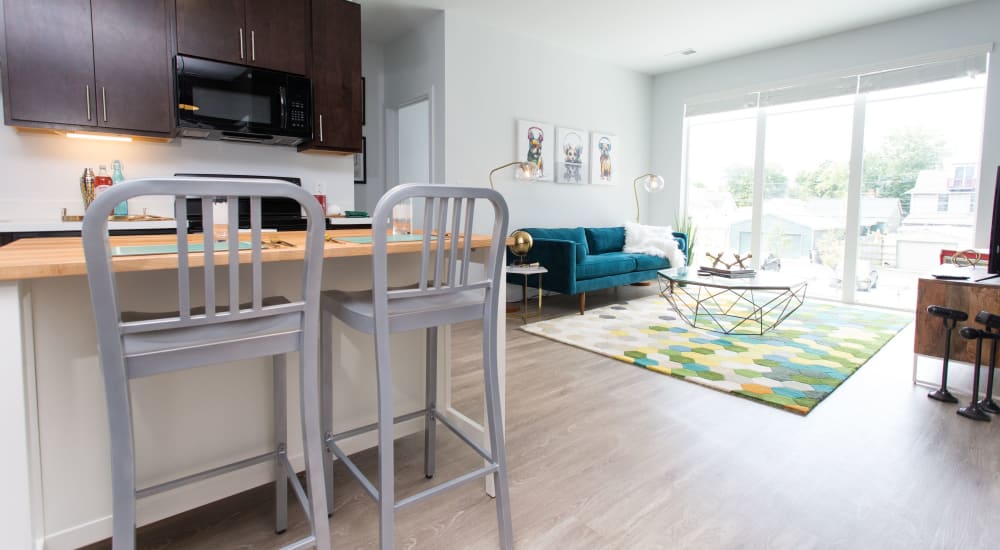 Kitchen with island and living room at Pinnex in Indianapolis, Indiana