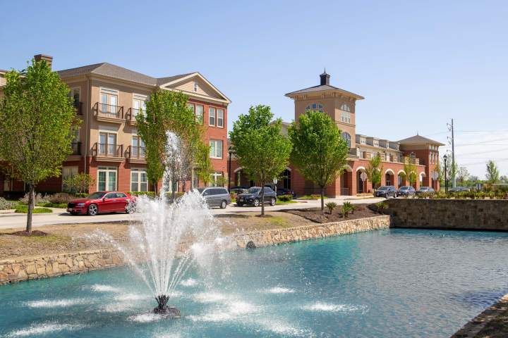 Discover The Landing at Watermere Frisco, a premier senior living community in Frisco, TX. This scenic image showcases the beautifully landscaped grounds, elegant architecture, and tranquil water feature, offering a glimpse into the serene and welcoming lifestyle residents enjoy.