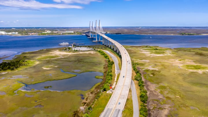 Aerial photo of Sidney Lanier Bridge in Brunswick with green area marshes in the foreground
