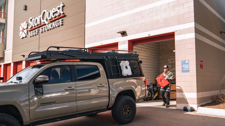 A small business owner moving supplies out of their storage unit.