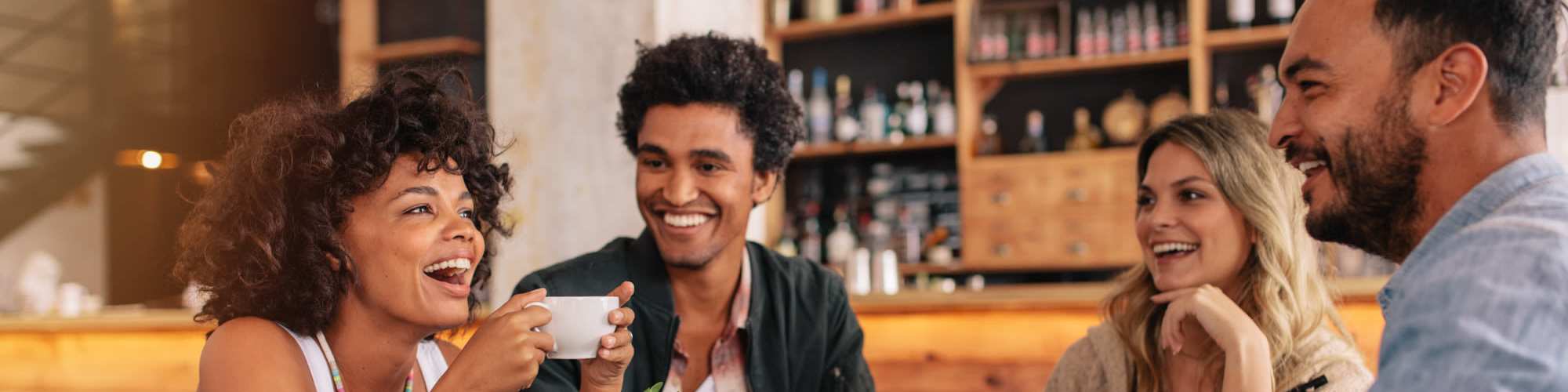 Neighborhood | A group of friends having coffee and laughing together in a nearby coffee shop Andanté in Seattle, Washington