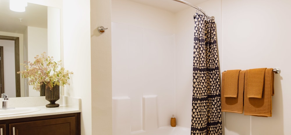 Bathrooms with tubs and showers at Markwood Apartments in Burlington, Washington