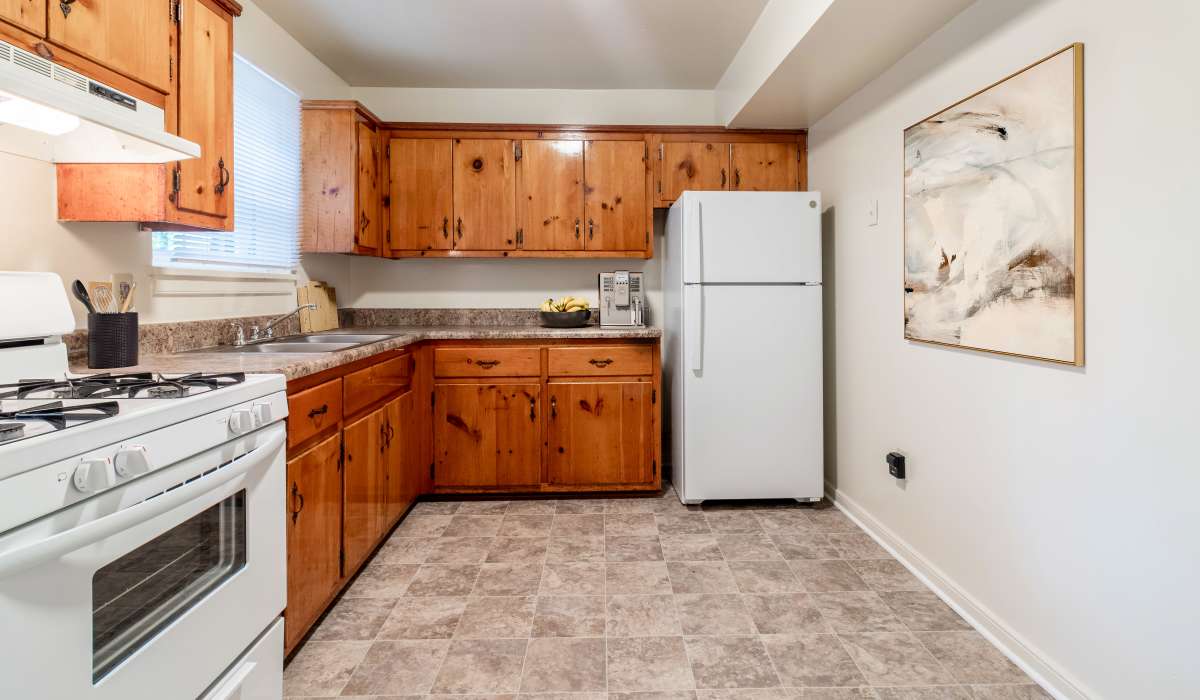 Kitchen with wooden cabinetry at Landmark at Gayton Apartments in Richmond, Virginia