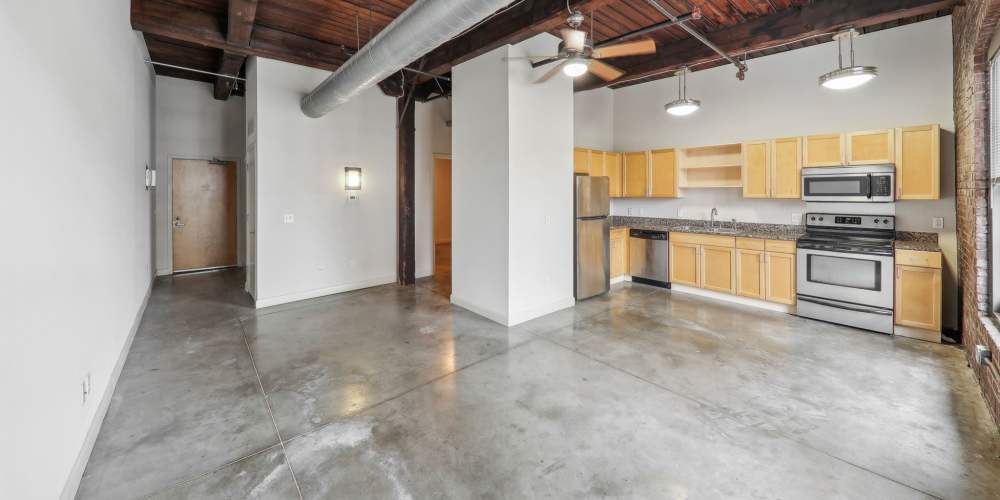 Unfurnished living room with ceiling fan at Stadium Loft Apartments in Saint Louis, Missouri