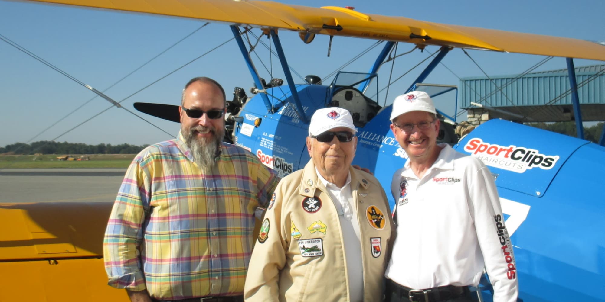 Residents from Bella Vista Gracious Retirement Living in Asheville, North Carolina, in front of an old plane