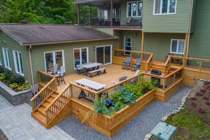 a large deck off he back side of a large home