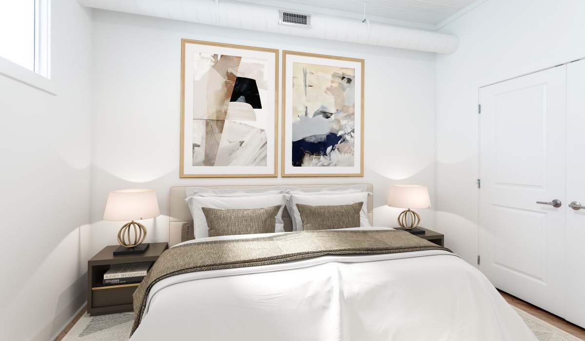 A well made king sized bed in a model apartment bedroom at Landmark at Marshall Broad in Richmond, Virginia