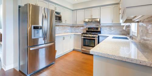 Fully-equipped kitchen with stainless steel appliances and granite countertop atVilla Creek in Santa Rosa, California
