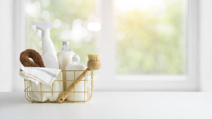 Eco-friendly natural cleaning products on table and window background