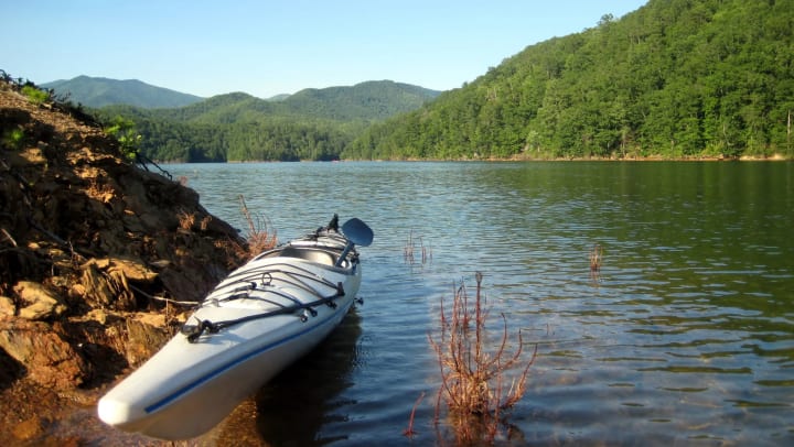 Kayak on the side of a lake.