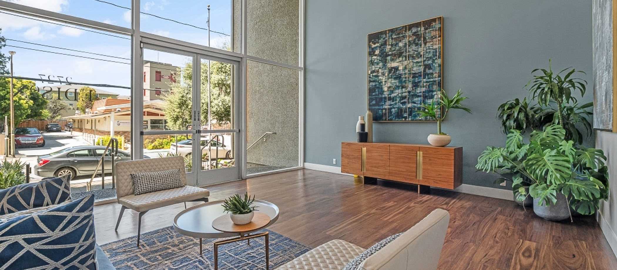 A spacious living room with hardwood floors and large windows, located at 2727 Edison in San Mateo, California.