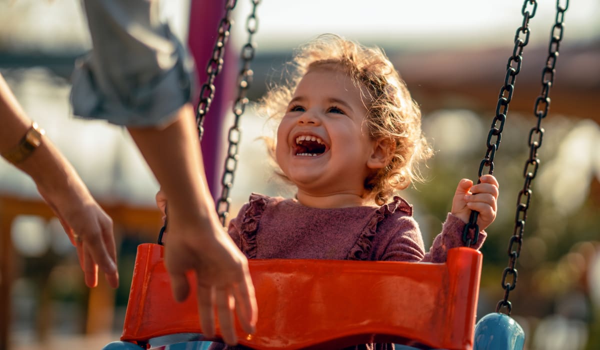 Child swing as mom pushes him at the playground at Grand Meridia Apartments in Rahway, New Jersey