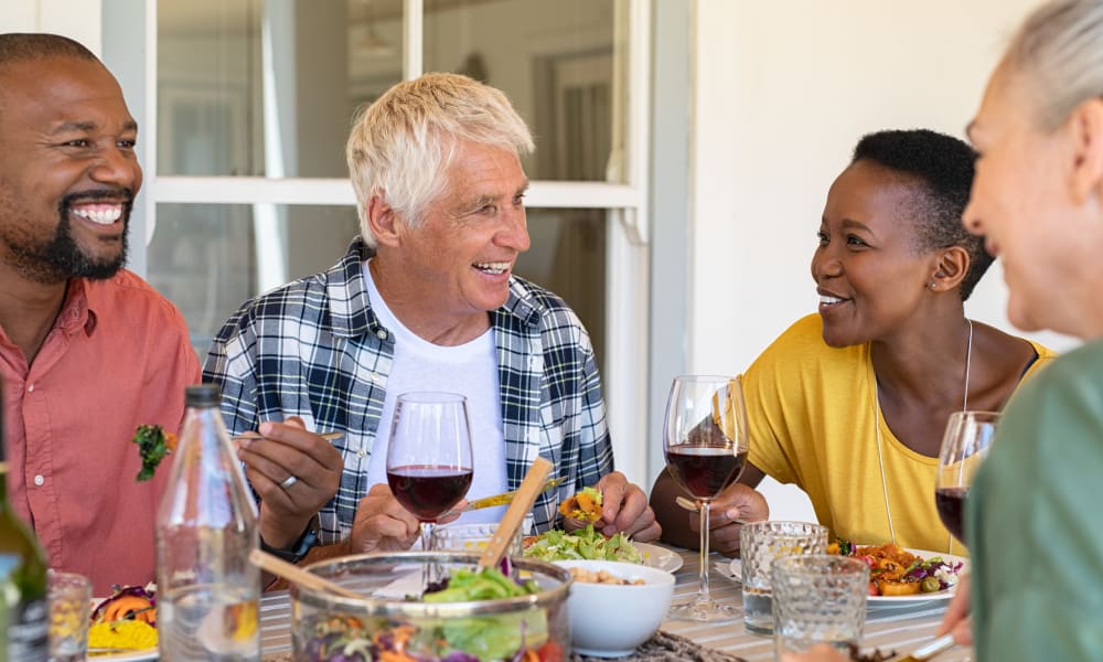 Family enjoying meal together in their Florida home at Viva Communities