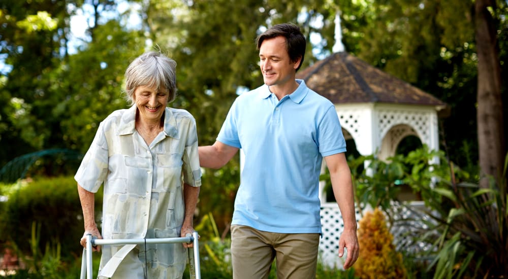 A staff member helping a patient walk at Careage Home Health in Bellevue, Washington. 