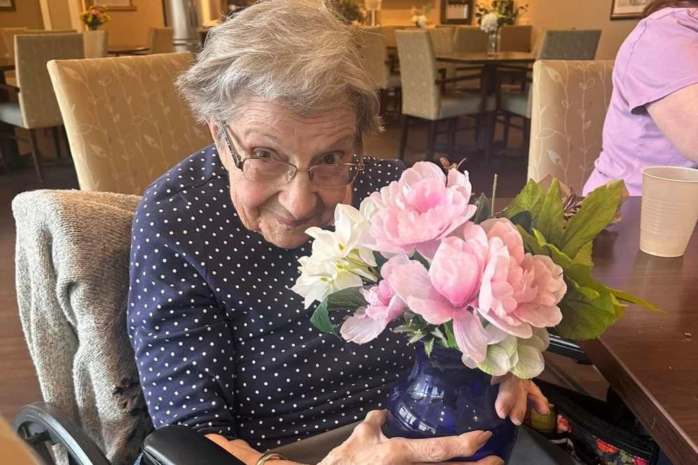 Senior loving flower bouque at Legacy Living Lexington in Lexington, Kentucky