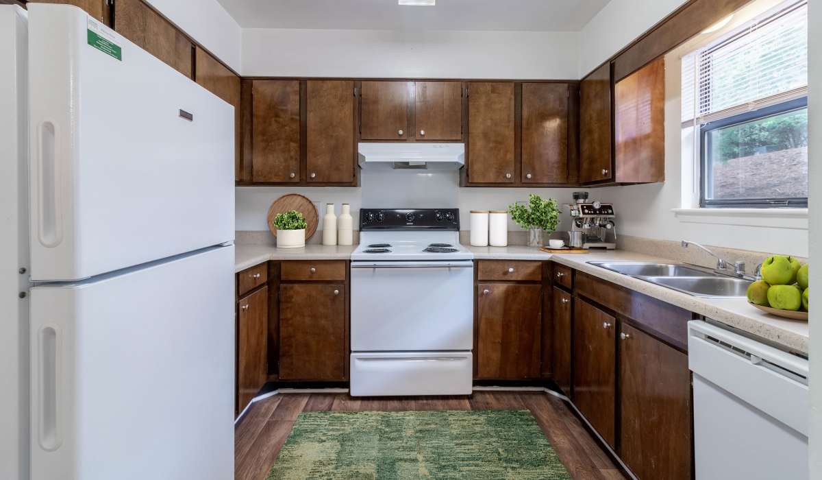 Kitchen with wood cabinets at Tanglewood Apartments in Southern Pines, North Carolina