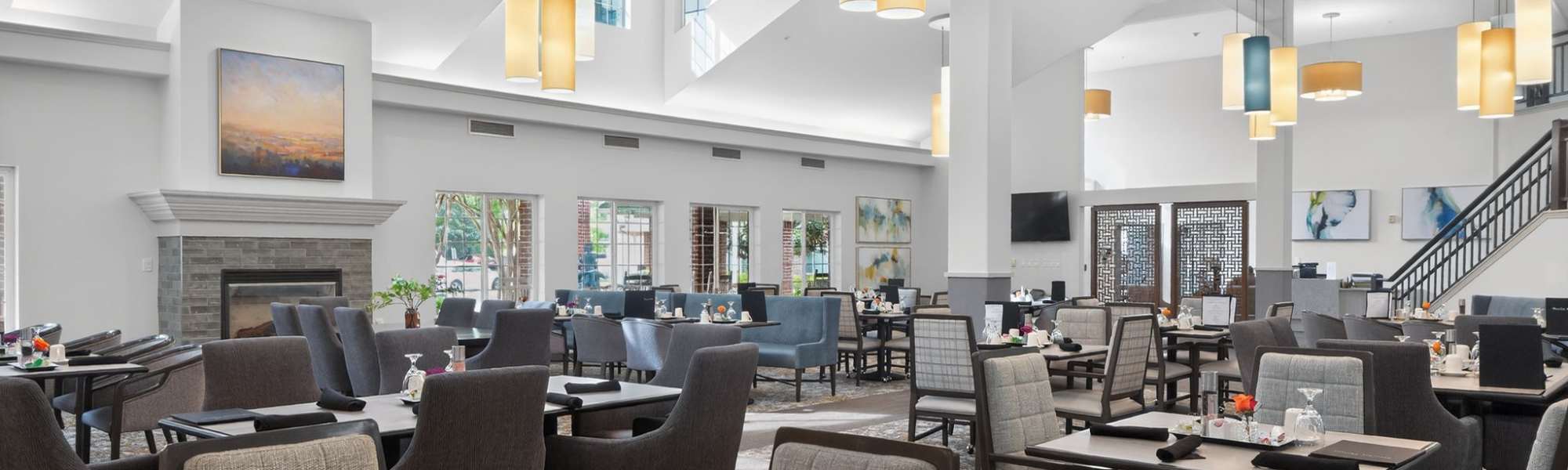 Elegant restaurant-style dining room with fireplace and modern lighting at Dogwood Terrace by Barclay House in Henrico, Virginia