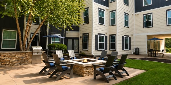 Outdoor courtyard with fire pit and seating area at The Den in Columbia, Missouri
