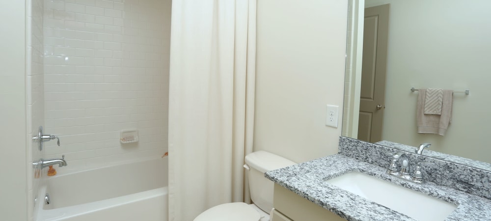Spacious bathroom with large mirror and ample counter space at 2370 Main at Sugarloaf in Duluth, Georgia