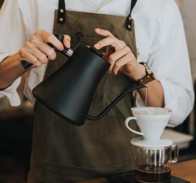 Barista pouring coffee near Randall Highlands in , IL