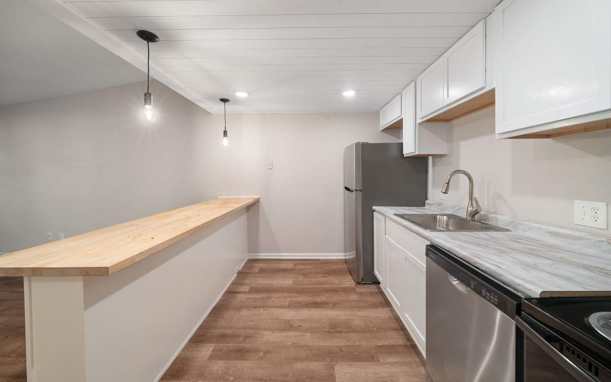 Modern kitchen with stainless appliances at Bay Vista Apartments in Daphne, Alabama