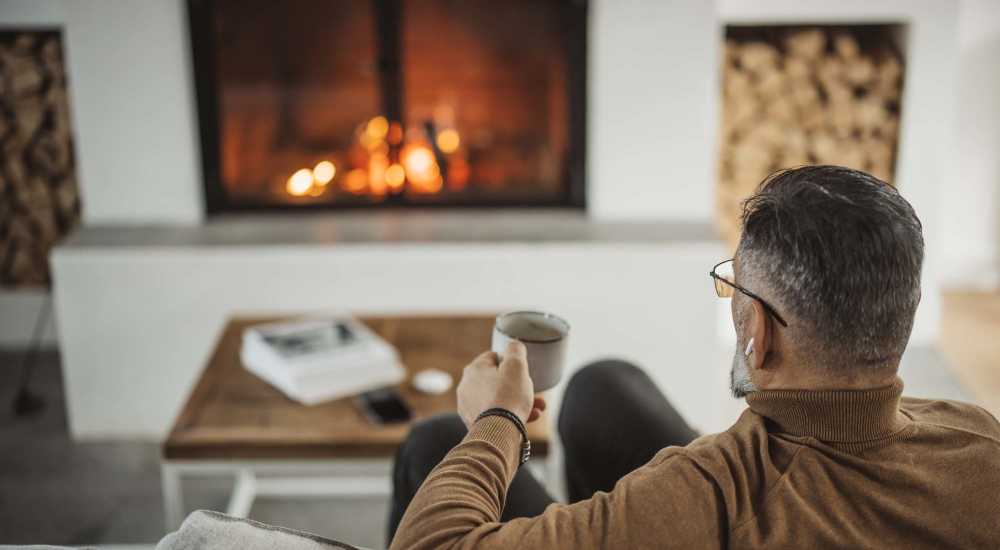 Apartment living room with a fireplace at Stadium West Apartments in Arlington, Texas