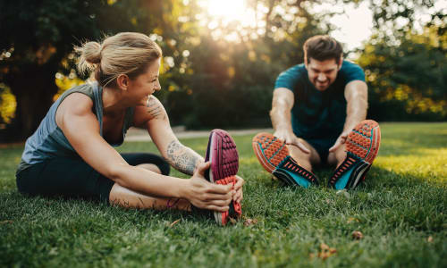 Residents stretch before a run in the park near Marina Breeze in San Leandro, California