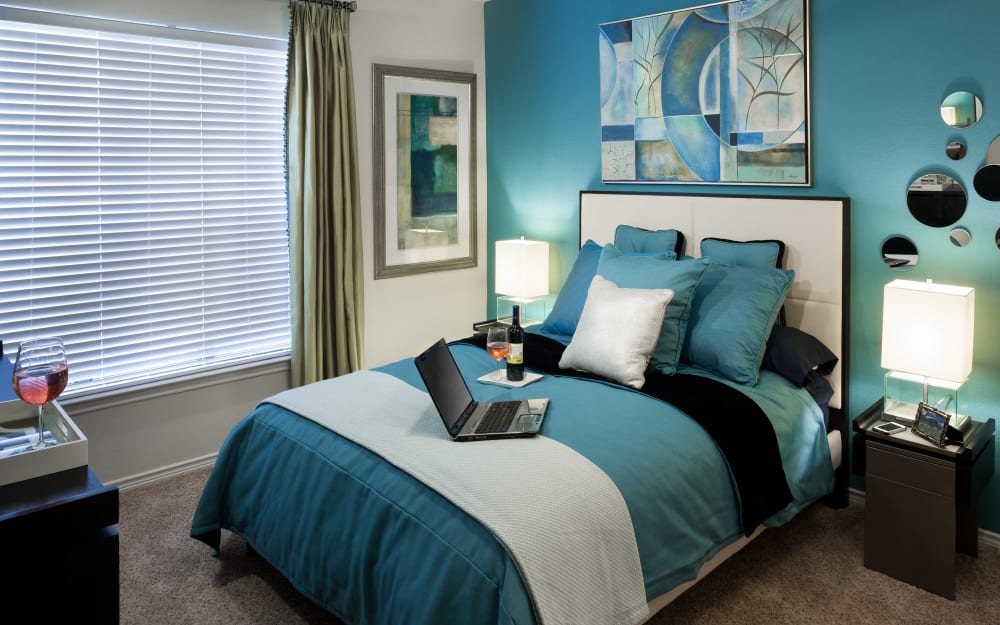 Master bedroom with a large window for natural lighting at The Asten at Ribelin Ranch in Austin, Texas
